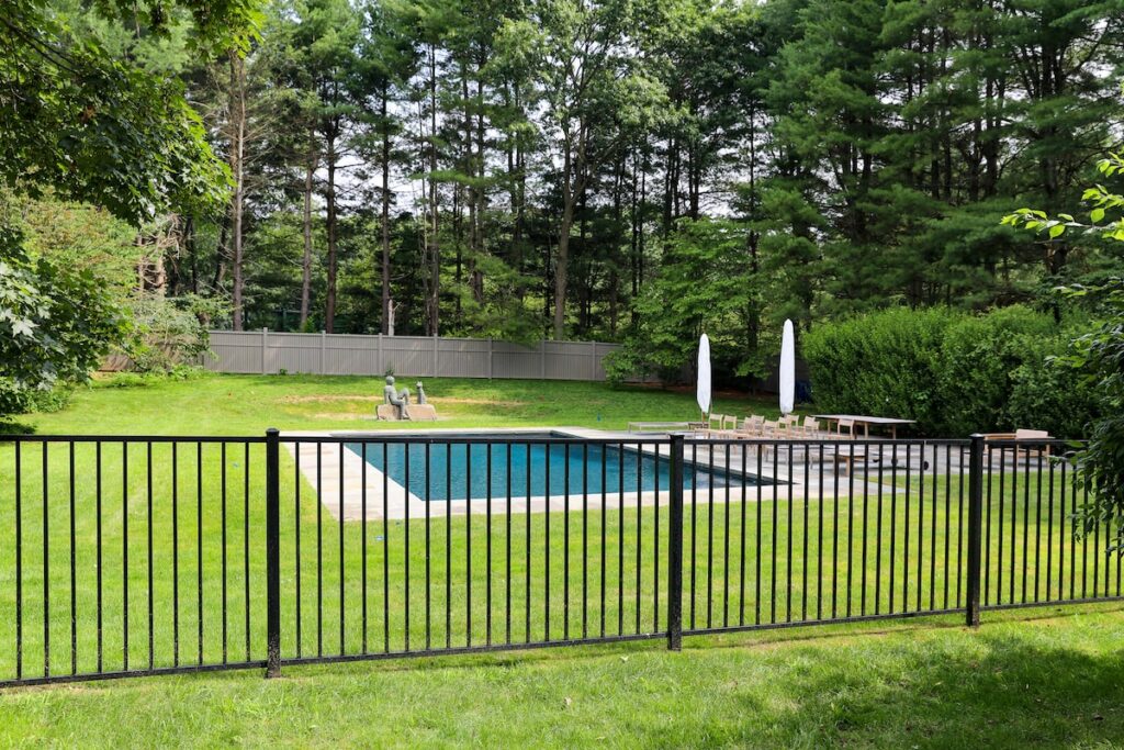 black aluminum fence with pool in the background