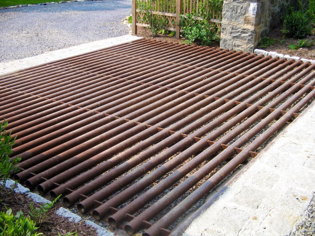 A metal cattle guard prevents deer from crossing this path.