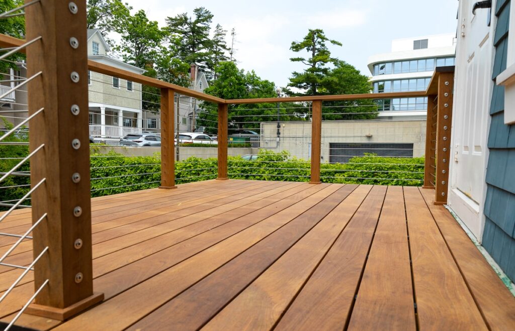 A wood deck with cable railings and wood posts.