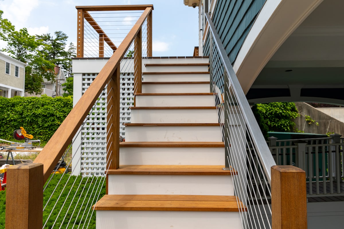 painted wooden deck stairs with cable railing