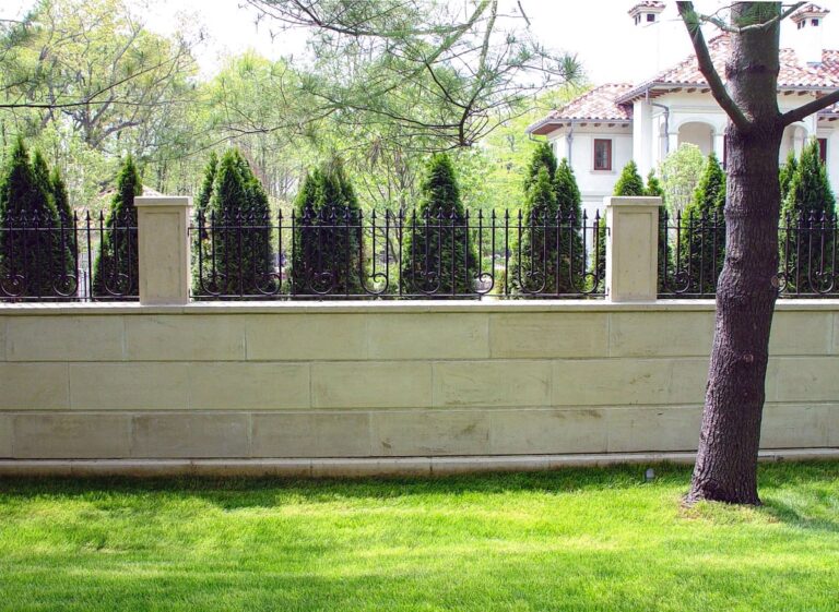 wrought iron and stonework deer fence
