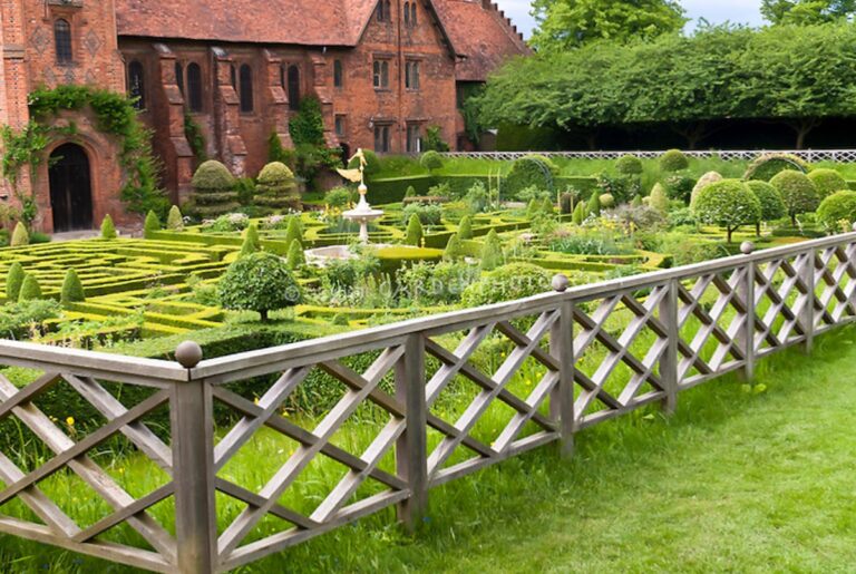 A gray wood fence with decorative diagonal slats.