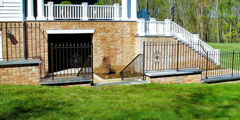 Wrought iron metal fence panels along an incline.