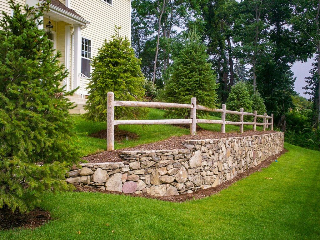simple post rail fence with stonework