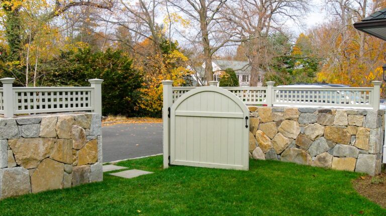 wood and stone fence with wood walk gate