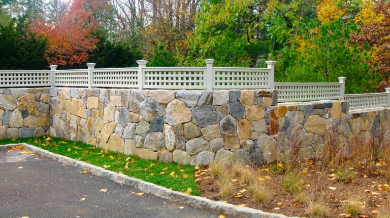 gray wood fencing with stonework foundation