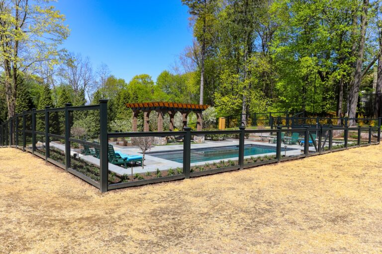 green mesh and wood pool fence full view