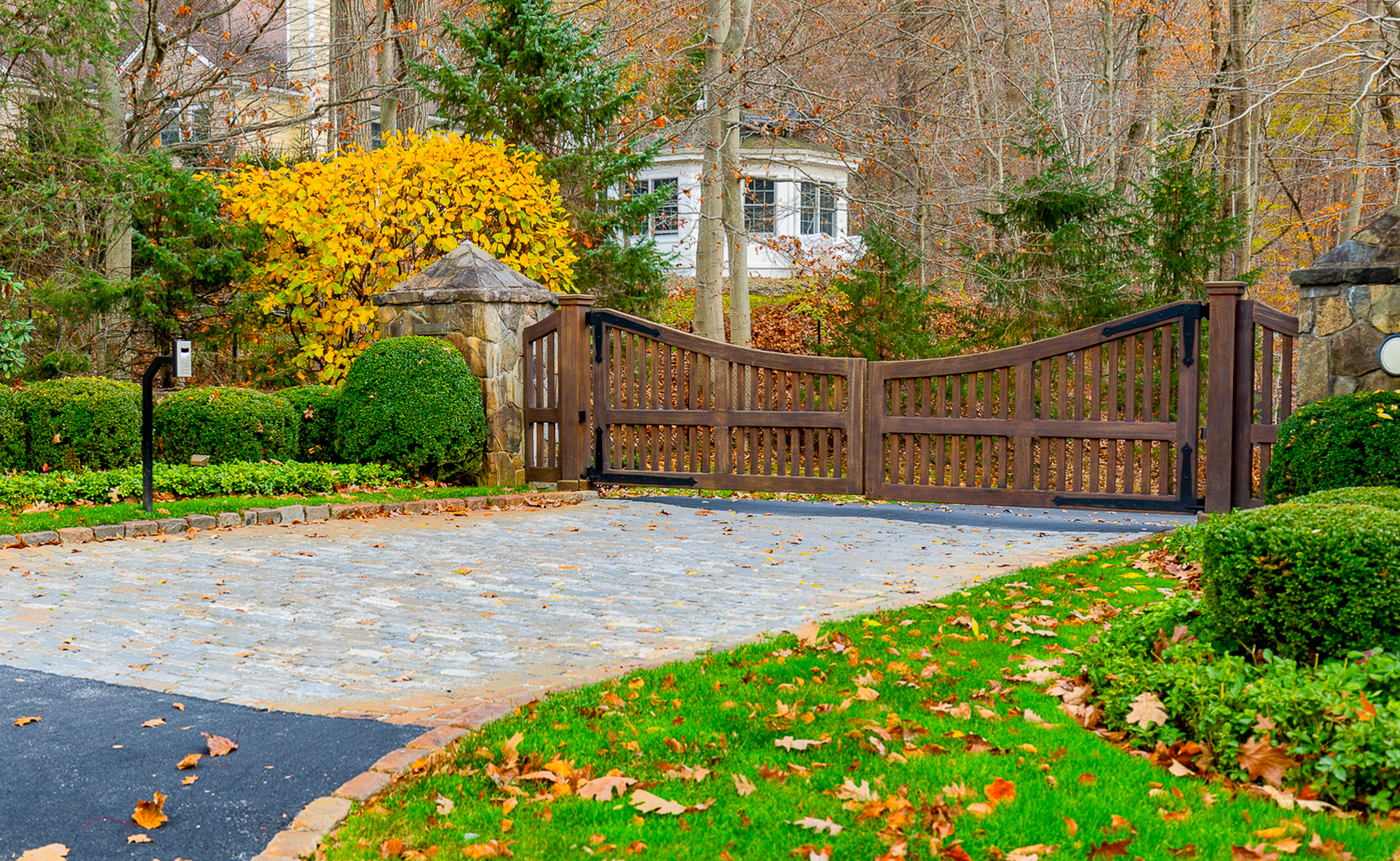 classic wooden gate with robust timber stained dark in color