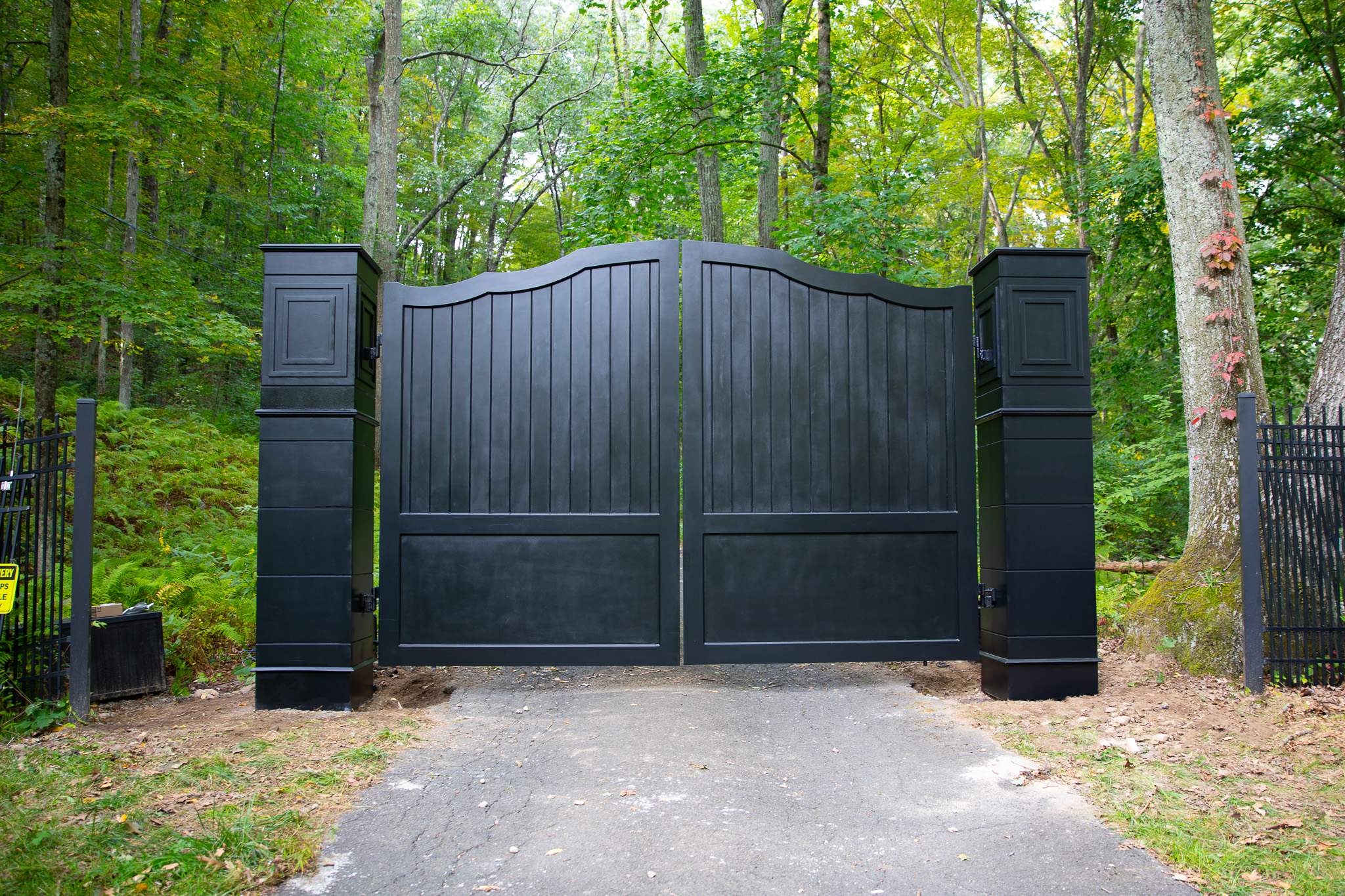 Strong composite driveway gate painted black with black pillars