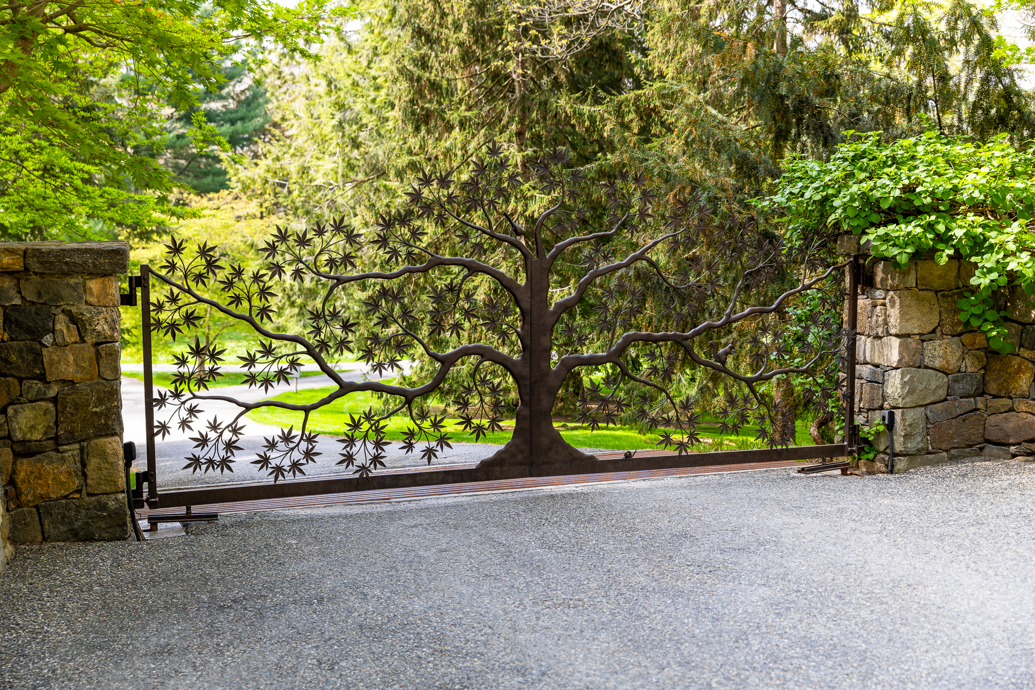 Custom one-of-a-kind driveway gate with metal tree of life design