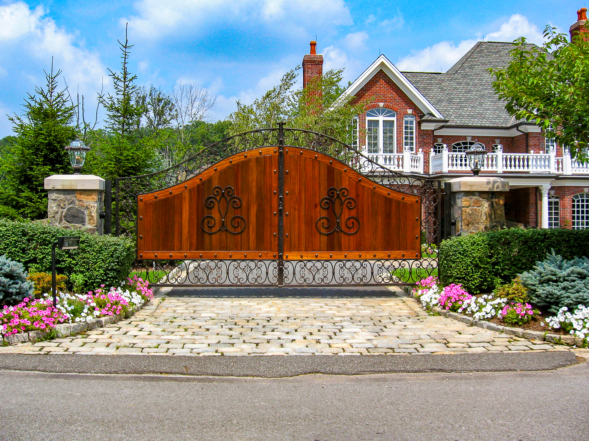 Stunning wood and metal driveway gate with detailed metalwork