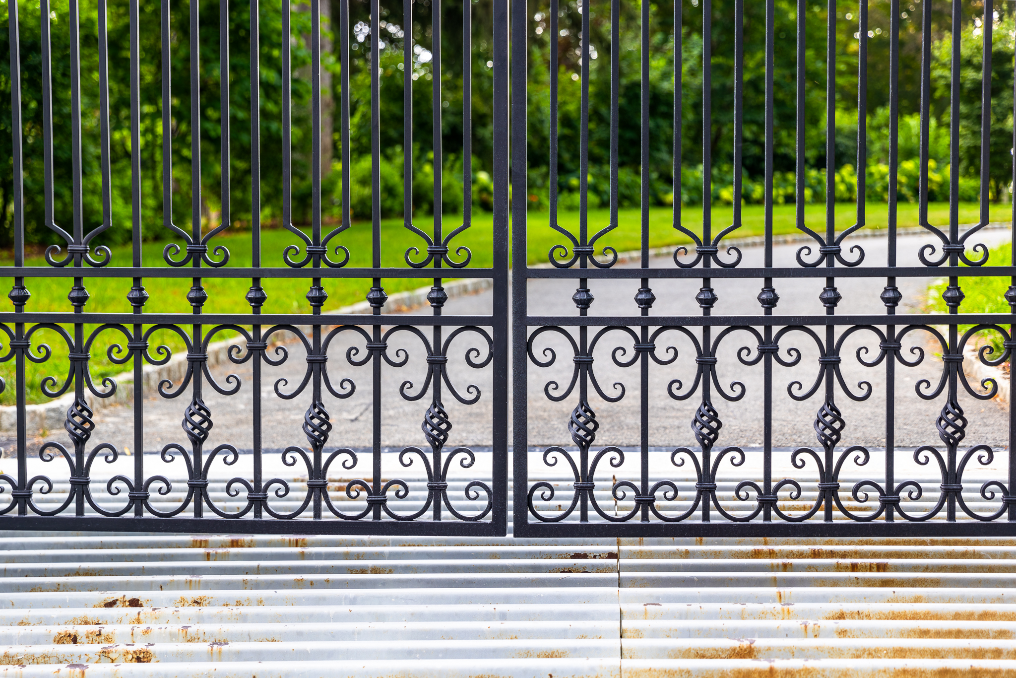 Intricate scrollwork at the bottom of this wrought iron gate