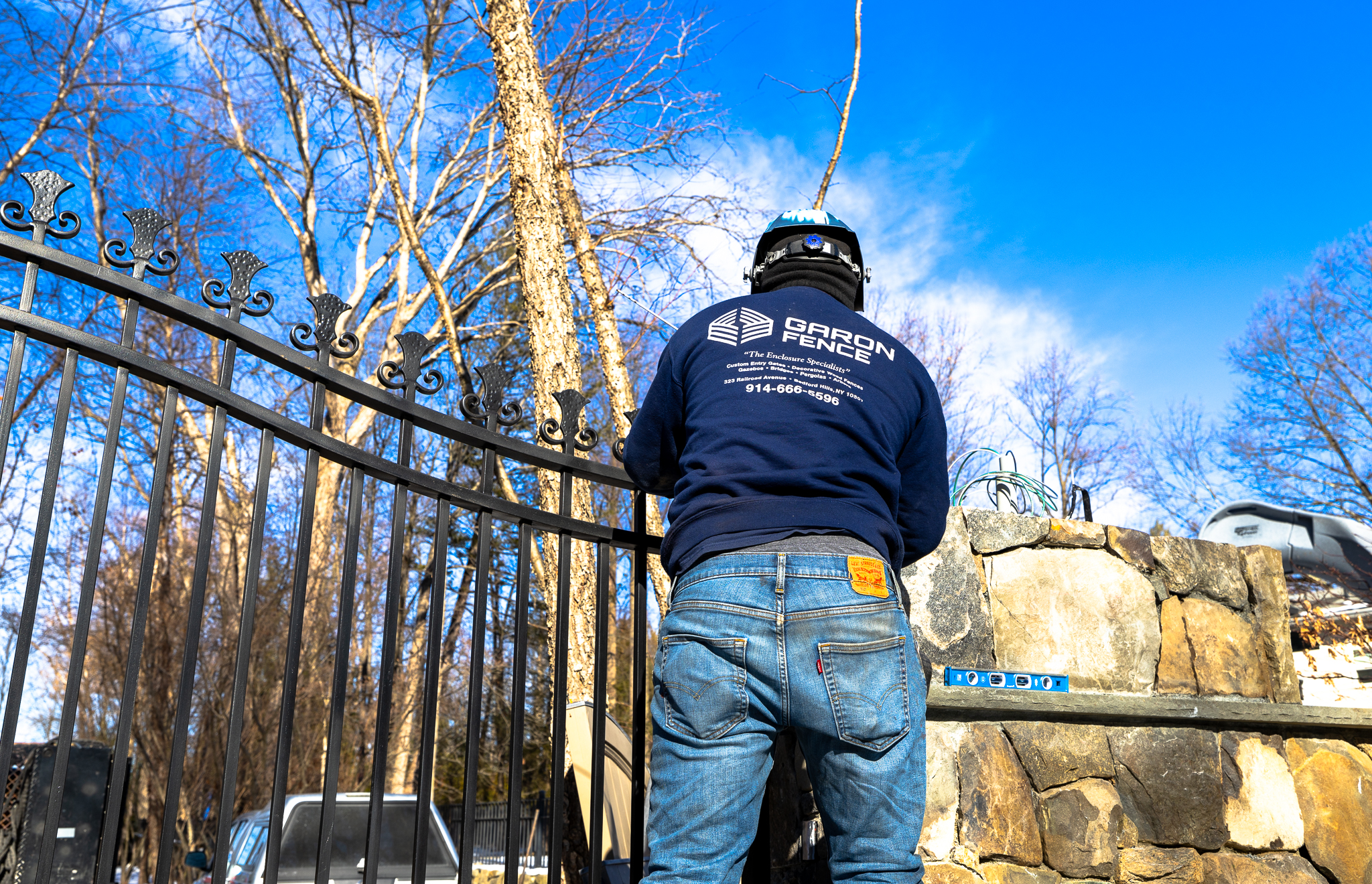 Garon Fence installing custom wrought iron driveway gate