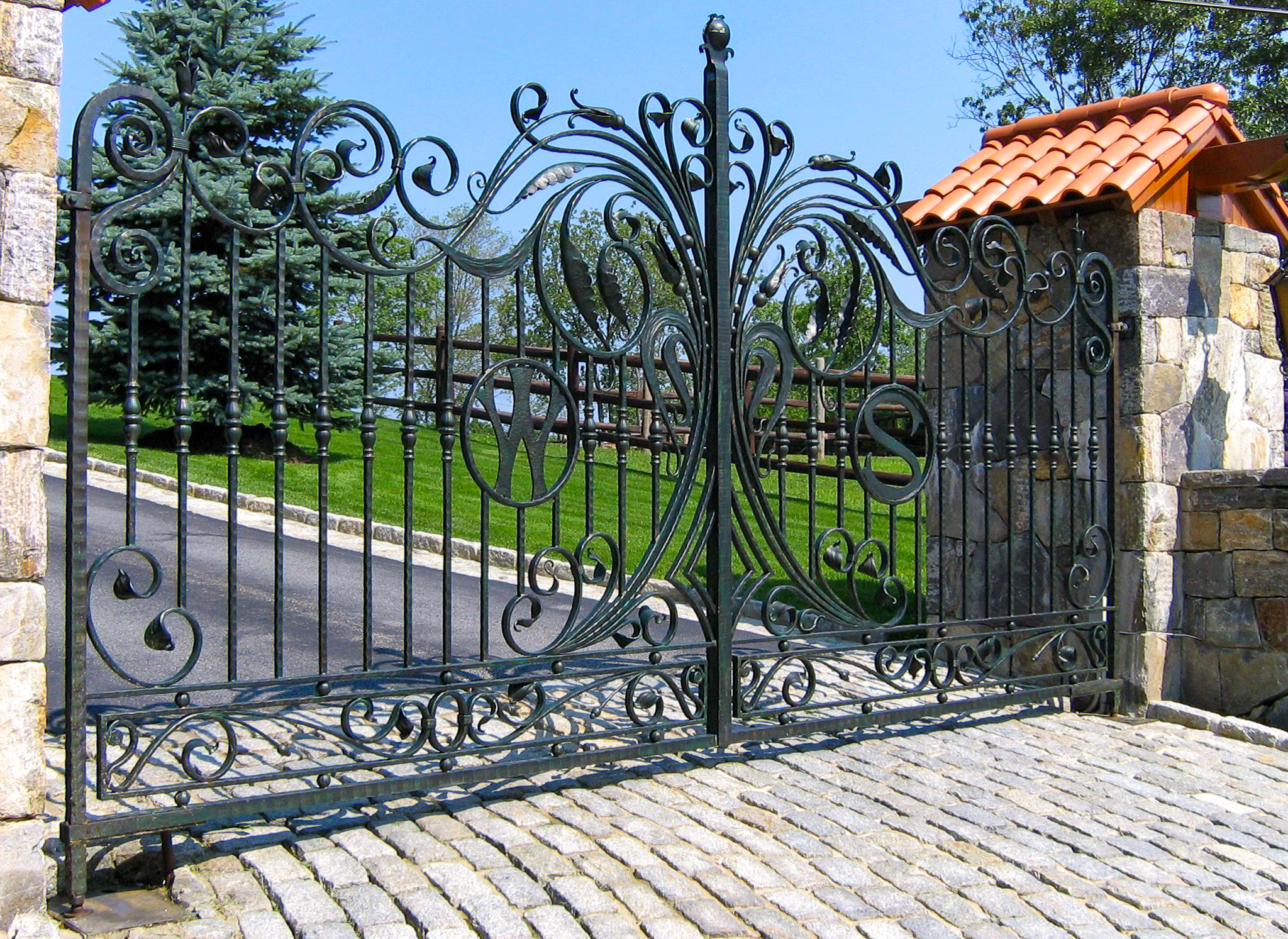Elegant wrought iron driveway gate with European influence
