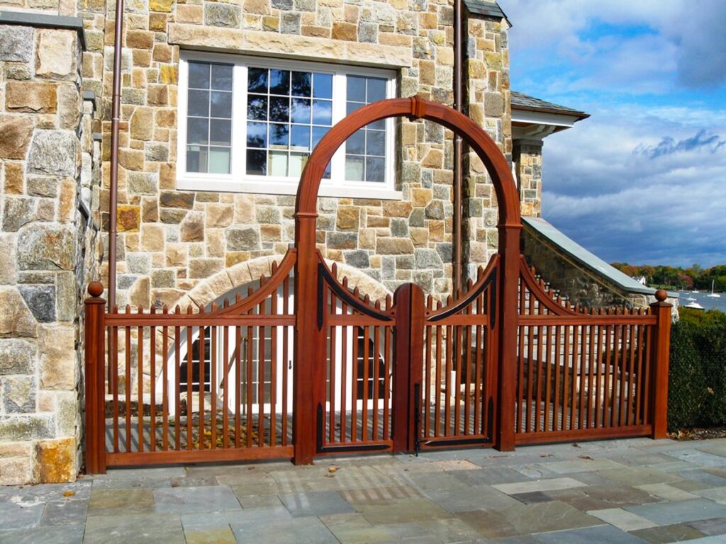 circular arched mahogany wood arbor for stone house