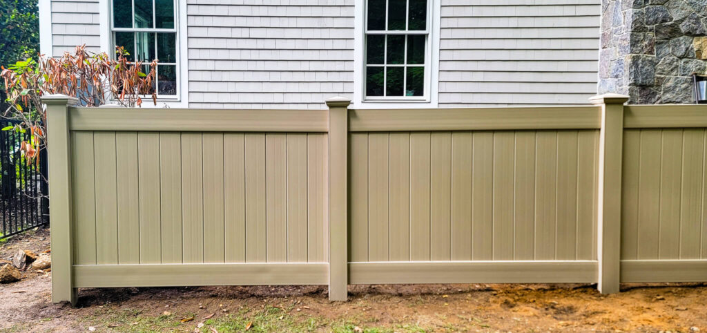 beige vinyl fencing for the side of the home's property