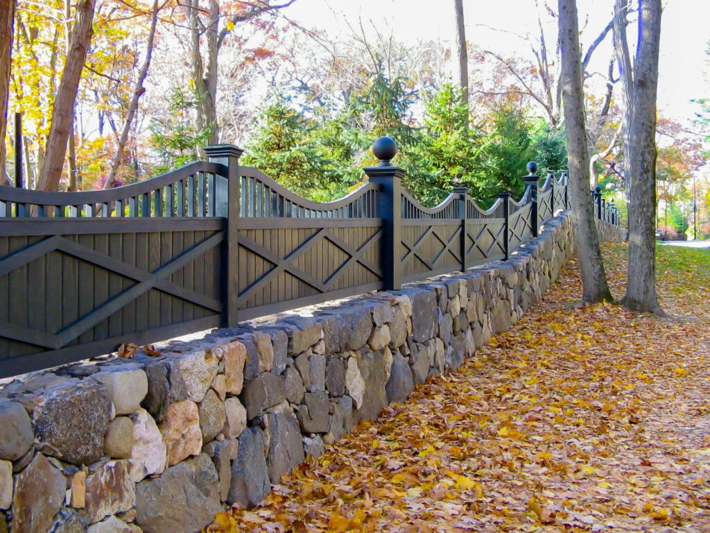 beautiful custom wood fence built on a stone wall