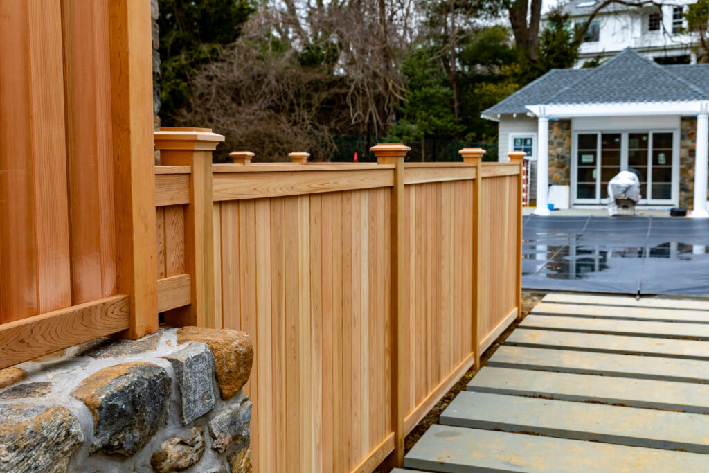 vertical wood fence offers natural beauty vs vinyl alternatives