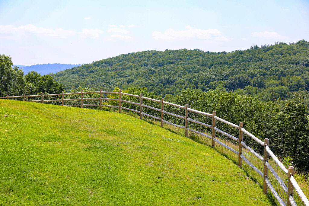 classic horizontal post and rail fence with a scenic overlook