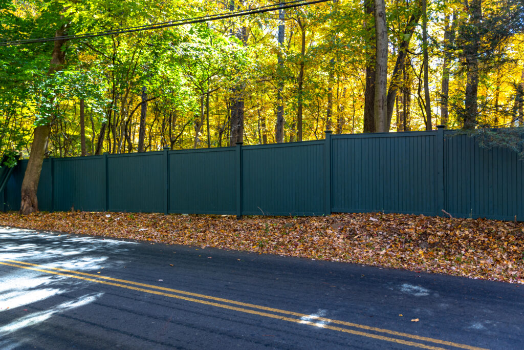 Wood fence along a scenic road at privacy height