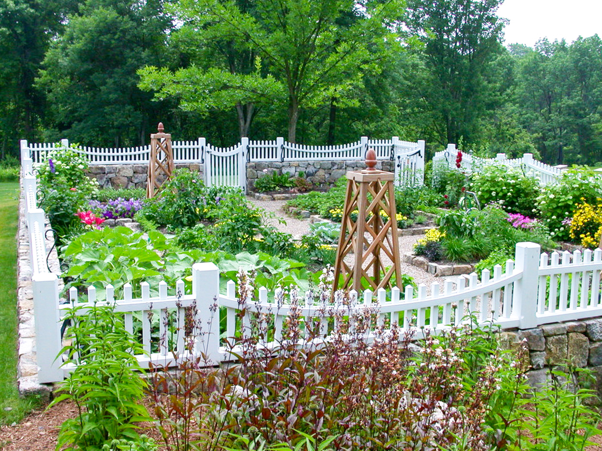 white picket garden fence with stone work