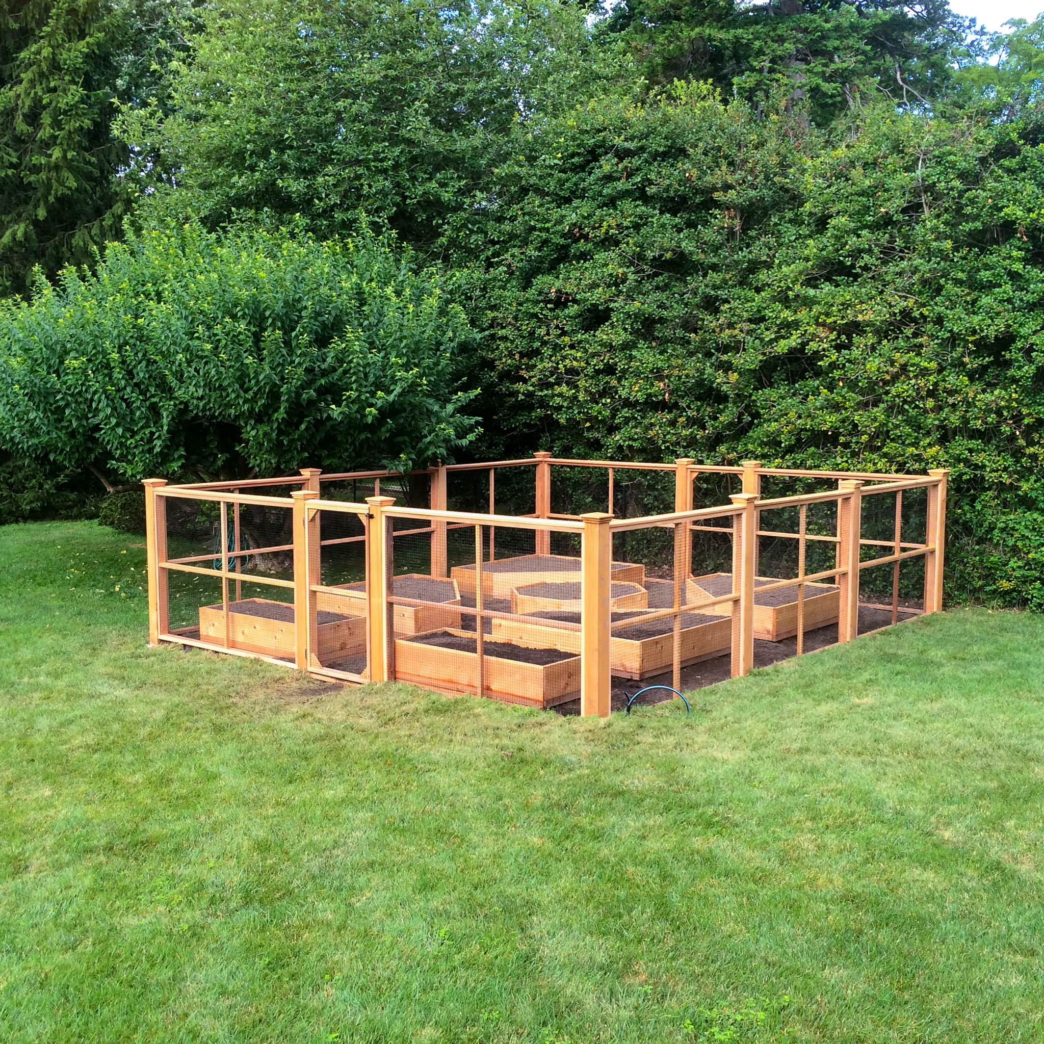 Enclosed Garden Fence Ideas with Cedar Wood Framing and Raised Beds