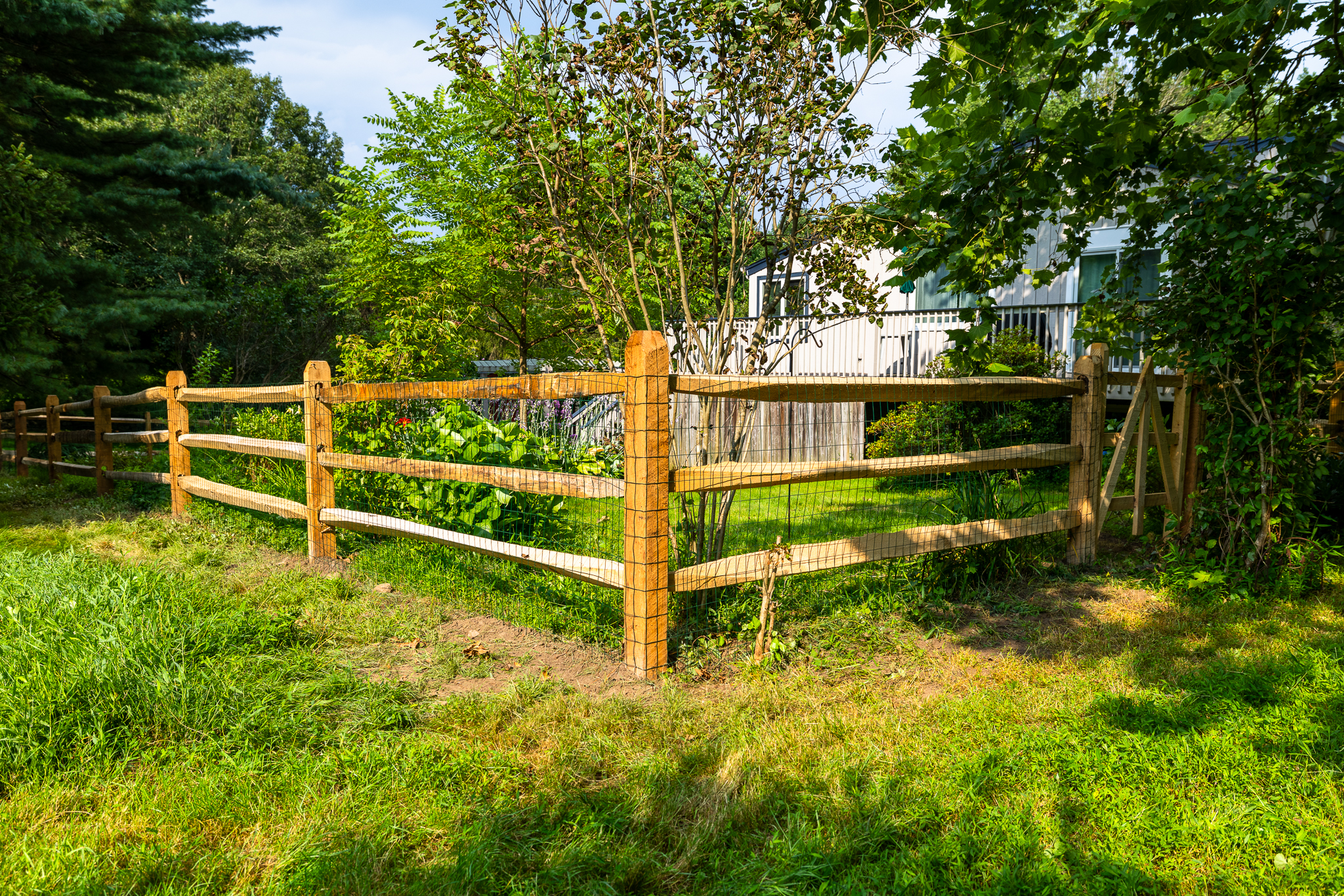 Corner Post of a Post-and-Rail Fence in the Lush Garden Landscape