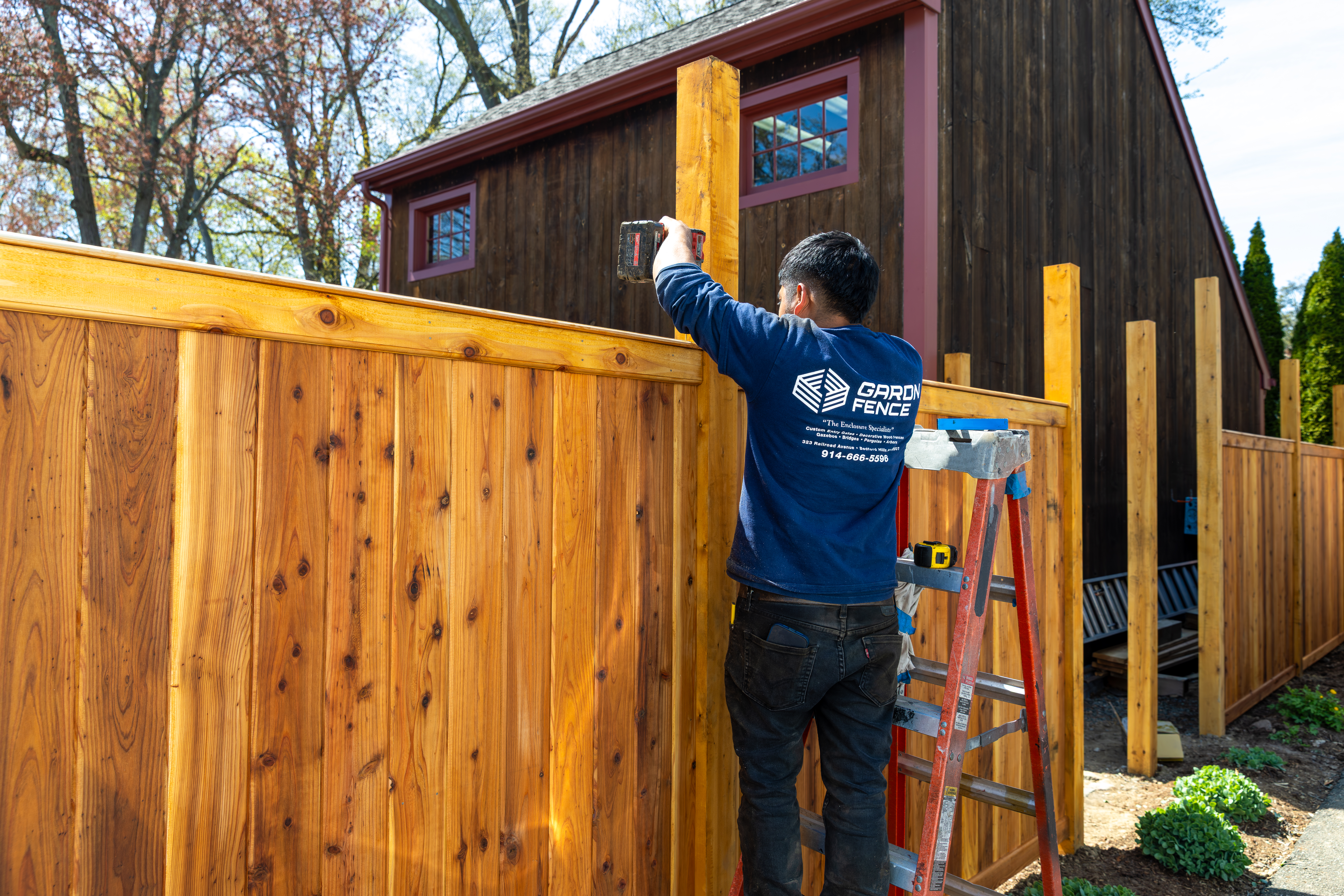 Garon Fence contractor installing a wood security/privacy fence for home